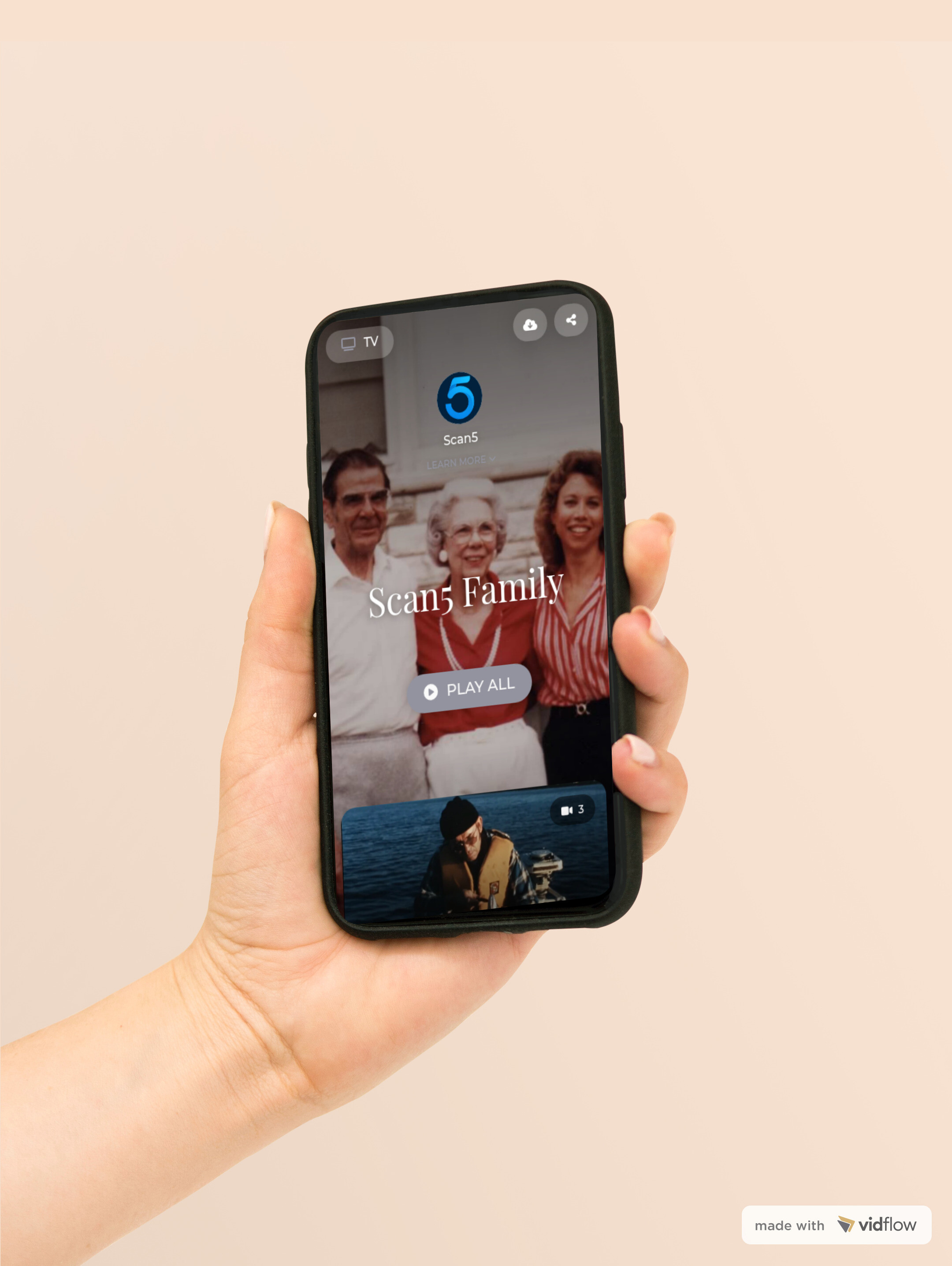 Person holding a phone showing Scan5 family gallery